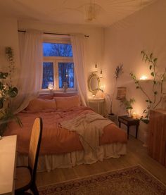 a bed room with a neatly made bed next to a window and candles on the wall