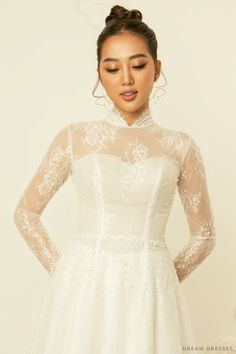 Our sweet and stylish Calixta white bridal ao dai is the perfect ensemble for modern brides who love a whimsy, girly aesthetic. Calixta features a flare A-line bottom, sheer, couture French lace detailing, silk pants, and a classic high collar. This gorgeous, romantic ao dai is the ideal fusion of traditional and modern elements. Feel unique, classy, and elegant in Calixta! Detail: White Vietnamese Ao Dai Collar: 1.2''/3cm Long sleeves Bra cups added Zipper closure Flare A-line bottom Floor len White Wedding Dress With Fitted Bodice For Ceremony, Fitted Ao Dai With Lace Sleeves For Wedding, White Fitted Bodice Wedding Dress For Ceremony, Lace Ao Dai For Wedding, White Fitted Ao Dai For Wedding, White Gown With Lace Bodice For Bride, Fitted White Ao Dai For Ceremonies, White Lace Bodice Wedding Dress For Bride, White Wedding Dress With Lace Sleeves For Evening