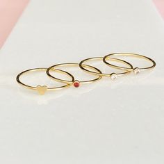 "Our gold filled Valentine's Day stacking rings are the perfect gift for a loved one. Choose from our 14kt gold filled Swarovski Crystal rings available in rose, red and diamond pair with a heart ring. The perfect stack to say I love you! DETAILS & SIZE *Swarovski Crystal Stone Options: Garnet, Diamond, Rose *Available in our high-quality 14kt gold-filled *Gemstone: 2 mm *Every purchase comes in a Tangerine branded gift box. *Handcrafted with care in Seattle WA *We LOVE what we create and wa Gold Stackable Gemstone Rings For Gifts, Dainty Birthstone Midi Rings For Gifts, Gold Gemstone Midi Rings For Anniversary, Gold Heart-shaped Stackable Midi Rings, Gold Stackable Heart Midi Rings, Dainty Stackable Midi Rings For Valentine's Day, Dainty Heart-shaped Stackable Rings As Gift, Dainty Heart-shaped Stackable Rings For Gifts, Stackable Rose Gold Birthstone Ring Gift