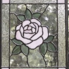 a stained glass window with a rose on it