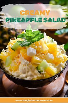 a close up of a bowl of food with the words creamy pineapple salad