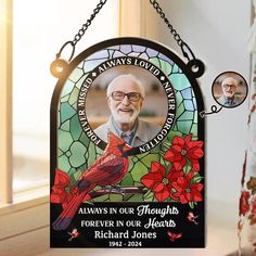 a stained glass memorial sign with a cardinal on it's front and the words, always in our hearts