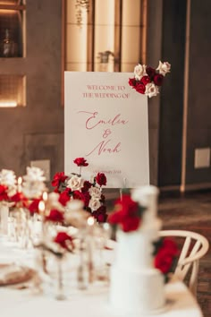 a sign that says welcome to the bride and groom on top of a table with flowers