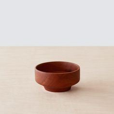 a wooden bowl sitting on top of a table