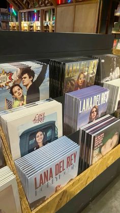 many dvds are stacked on top of each other in a display case at a bookstore