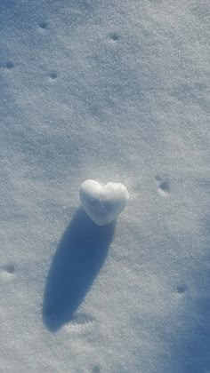 a heart shaped object is in the snow