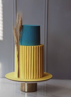 a yellow and blue cake sitting on top of a table