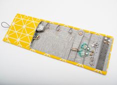 a yellow and white place mat with jewelry on it