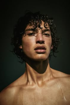 a young man with wet hair and no shirt is looking at the camera while he has his eyes closed