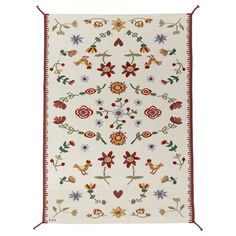 a white and red rug with flowers on it