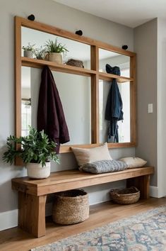 a wooden bench sitting under a mirror next to a potted plant on top of a rug