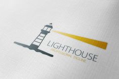 the lighthouse logo is shown on a white shirt with yellow trims and a light house