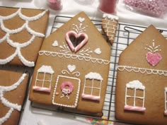 gingerbread houses decorated with pink and white icing