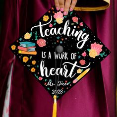 a person wearing a graduation cap that says teaching is a work of heart