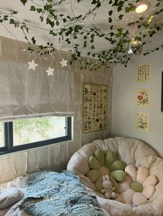 a bed with stuffed animals on top of it in a room that has ivy growing all over the ceiling