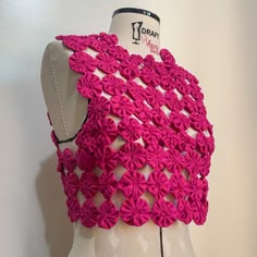 a mannequin with pink flowers on it's chest and back, made out of plastic