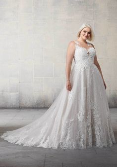 a woman in a wedding dress posing for the camera