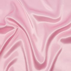 a pink satin fabric textured with folds and waves in the center, as if it were made from silk or polyester