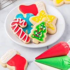 decorated christmas cookies on a white plate