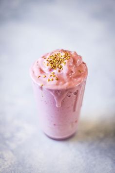 a pink smoothie with sprinkles on top