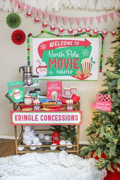 a christmas display in the corner of a room with a sign that says north pole movie theater