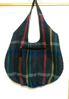 Large hobo bag with boho colors and features is 13.5" high at center of bag above the outside zipper by 21" wide at its widest point. The bag is made of gray tweed plaid.  Colors are gray, pink, blue, purple and teal. There are 2 zipper pockets; one exterior and one interior.  The recycled handle fits the purse perfectly.  Bag is made from the Diana Tote Bag Pattern by Delinda Boutique. Lining is gray taffeta. Use for book bag, knitting or crochet bag, lunch bag, gift bag, shopping bag, everyday bag or whatever you need it for. Bohemian Multicolor Bags For Fall, Bohemian Multicolor Fall Bags, Fall Travel Hobo Bag With Zipper Pocket, Boho Colors, Large Hobo Bag, Bag Knitting, Bag Lunch, Grey Tweed, Tote Bag Pattern