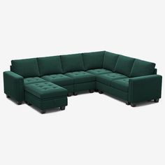 a green sectional couch sitting on top of a white floor next to a chair and ottoman