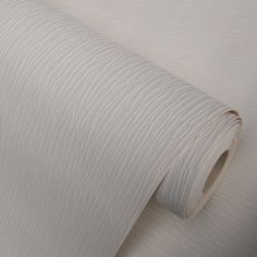 a roll of white fabric sitting on top of a table