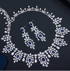 Ornate%20Sapphire%20Blue%20CZ%20Wedding%20Jewelry%20Set%0D%0AComplete%20your%20regal%20wedding%20day%20look%20with%20our%20elegant%20%22something%20blue%22%20Sapphire%20CZ%20necklace%20and%20earring%20set.%20This%20stunning%20platinum%20silver%20plated%20jewelry%20set%20is%20adorned%20with%20brilliant%20AAAAA%20quality%20clear%20and%20sapphire%20blue%20CZ%20crystals%20that%20will%20add%20dazzling%20sparkle%20to%20any%20wedding%20or%20special%20occasion%20ensemble.%26nbsp%3B%0D%0AYou'll%20feel%20like%20royalty%20wearing%20this%20ornately%20designed%20jewelry%20set!%0D%0ASize%3A%20The%20necklace%20is%20about%2016%22%20long%20and%20the%20pierced%20earrings%20are%26nbsp%3B%20about%202.2%22%20long%20and%20.7%22%20wide.%0D%0AColor%3A%20Silver%2FSapphire%20Blue%2FClear.%0D%0AStyle%3A%20ne1011S-S. Quinceanera Tiaras, Formal Jewelry, Wedding Jewelry Set, Bling Wedding, Cz Necklace, Set Style, Silver Plated Jewelry, Price Tags, Wedding Jewelry Sets