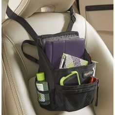 the back seat pocket is filled with various items and gadgets in its holder,