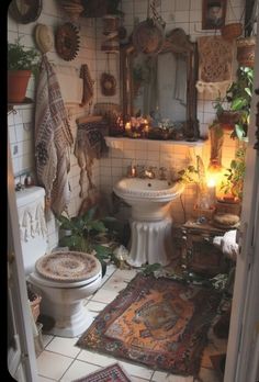 a bathroom with a toilet, sink and rugs