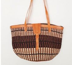 a brown and white striped bag hanging on a wall