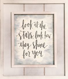 a white frame with black lettering on it that says look at the stars, look how they shine for you