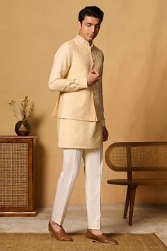 Yellow bundi featuring thread embroidered floral motifs with placed sequin bead embellishments. Paired with an inner kurta and pant., Fit: Relaxed Luxury Men's Nehru Jacket With Floral Embroidery, Semi-stitched Nehru Jacket With Intricate Embroidery, Embroidered Beige Nehru Jacket, Designer Long-sleeve Embroidered Nehru Jacket, Pink Embroidered Nehru Jacket Kurta, Beaded Neckline, Cocktail Reception, Nehru Jackets, Kurta With Pants