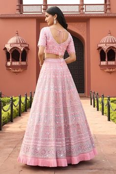 Pink lehenga featuring detailed floral embroidery with a pleated frill hem. Paired with a matching blouse and a scalloped border dupatta., Fit: Relaxed Floor-length Pink Choli With Cutdana, Pink Floor-length Lehenga For Navratri, Pink Floor-length Choli With Pallu, Pink Gown With Unstitched Blouse For Navratri, Pink Bollywood Gown With Unstitched Blouse, Floor-length Fitted Pink Choli, Fitted Pink Gown With Cutdana, Fitted Pink Gown With Cutdana Details, Designer Pink Gown With Chikankari Embroidery