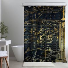 a bathroom with a black and gold shower curtain in the shape of a city map