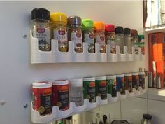 spices and condiments are lined up on the wall