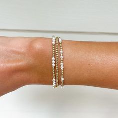 This beautiful, dainty bracelet stack is made of 2mm 14k gold filled beads and 3mm Swarovski crystal glass pearls. Each bracelet is perfect to wear on its own or part of the stack. The 14k beads can be worn in all conditions and will not fade or rust over time. Each bracelet is hand crafted and made to order. Perfect for bridesmaid gifts or for women and girls of all ages.  The stack includes a 2mm 14k gold beaded bracelet, a scattered 14k gold filled and pearl scattered beaded bracelet, and a 1 Dainty Stackable Pearl Bracelet With Round Beads, Dainty Beaded Bangle Bracelets, Dainty Beaded Bracelets With Round Beads For Bridesmaid Gift, Dainty Stackable Beaded Bracelets - Cheap, Gold Dainty Beaded Bracelets For Bridesmaid Gift, Dainty Stackable Pearl Bracelet For Everyday, Adjustable Delicate 14k Gold Beaded Bracelet, Dainty Stackable Beaded Bracelets In 14k Gold, Dainty Gold Beaded Bracelets For Bridesmaids