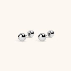 For the elegant minimalist, our Little Sphere Studs are now available in implant grade titanium for 24/7 waterproof, sweatproof, lifeproof wear. Specs & Sizing Made of medical-grade titanium Gold version is PVD plated with 18k gold Earring top is 3mm wide 20G post, 6mm wearable surface, 10mm total length Solid titanium ball backings for a sculptural look Starter Earrings, Nose Ring Jewelry, Tragus Conch, Piercing Shop, Flat Back Earrings, 18k Gold Earrings, Thread Earrings, Gold Earring, Cartilage Earrings