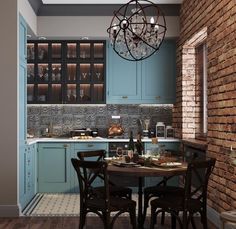 a dining table and chairs in a room with brick walls, blue cabinets and an iron chandelier