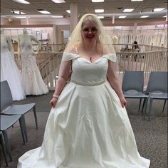 a woman in a white wedding dress posing for the camera