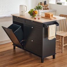 a kitchen island with a cutting board on it and a trash can in the middle