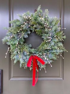 a christmas wreath hanging on the front door