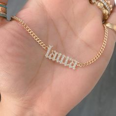 This unique personalized Old English font nameplate cut-out necklace is composed of 14K solid gold and beautifully pavé set with genuine GVs1 quality natural real Diamonds. This pendant is complemented by a durable 14K solid gold adjustable chain or can be purchased as a charm alone without the chain under the "Length" drop-down menu. NOTE: The item will be made in the exact casing of the characters entered. Please be mindful of this detail when providing the customization desired. Name Dimensio Luxury Classic Nameplate Necklace, Luxury Custom Nameplate Jewelry, Luxury Nameplate Jewelry, White Diamond Nameplate Jewelry, Custom Name Diamond Nameplate Jewelry, Personalized Gold Plated White Gold Necklace, Personalized White Gold Plated Custom Necklace, Personalized White Gold-plated Custom Necklace, Luxury Gold Necklace For Personalized Gift