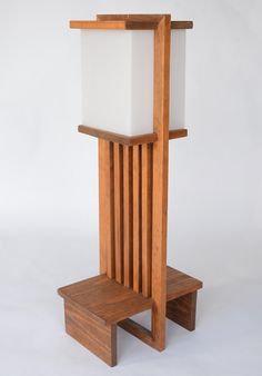 a wooden stand with a white square on it's top and two legs that are attached to each other