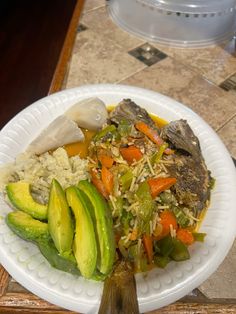 a white plate topped with vegetables and rice