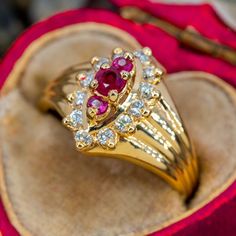 This elegant ring features rubies and diamonds and is crafted of 14k yellow gold. This ring is currently a size 5.5. One of the rubies is heavily chipped. Vintage Ruby Rings, Ruby Engagement Rings, Antique Gold Rings, Ruby Ring Vintage, Ruby Wedding Rings, Rubies And Diamonds, Ruby Diamond Ring, Ruby Ring Gold, Ruby Rings