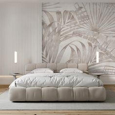 a large bed sitting in the middle of a bedroom next to a wall with palm leaves on it