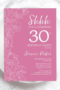 a pink and white birthday party with flowers on the front, it's a surprise