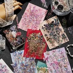 many different types of beads are on the floor next to some boxes and necklaces